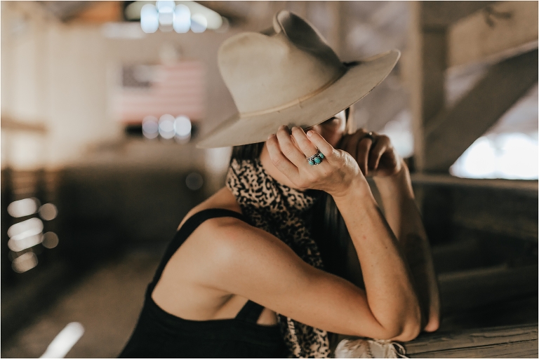 Western Fashion Style Inspo on the farm with Lindsay Branquinho in an old barn aisle and a vintage Stetson hat and a turquoise ring by Elizabeth Hay