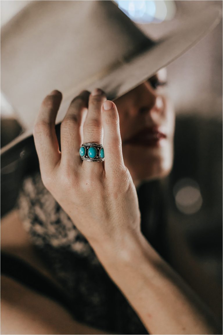 Western Fashion Style Inspo on the farm with Lindsay Branquinho in a barn aisle and a vintage Stetson hat and turquoise ring by Elizabeth Hay