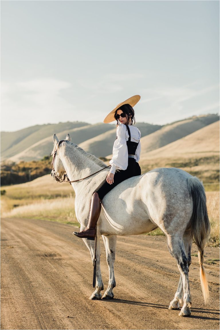 woman wearing couture with grey mare on county back road by California Equine Photographer Elizabeth Hay Photography