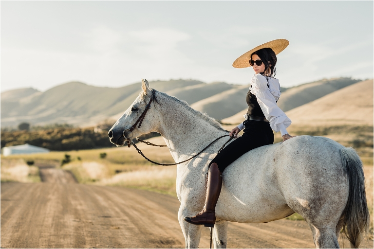 woman wearing couture with grey horse on Nipomo back road by California Equine Photographer Elizabeth Hay Photography