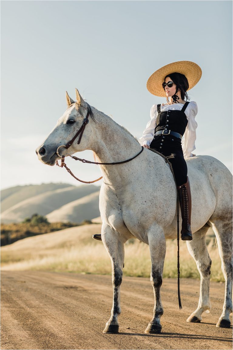 woman wearing Net a Porter style couture with grey horse on county back road by California Equine Photographer Elizabeth Hay Photography