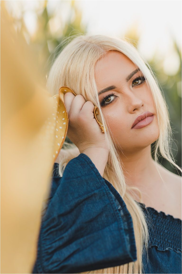 Blonde girl wearing denim top and yellow wild rag in a corn field by California Equine Photographer Elizabeth Hay Photography.
