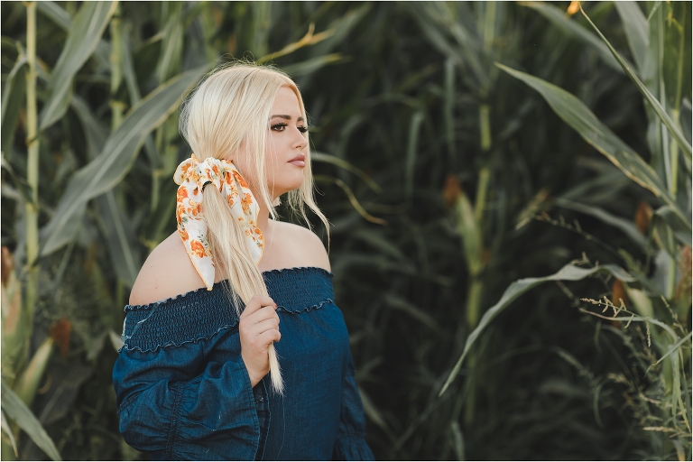 Blonde girl wearing denim top and orange and white wild rag in a corn field by California Equine Photographer Elizabeth Hay Photography.