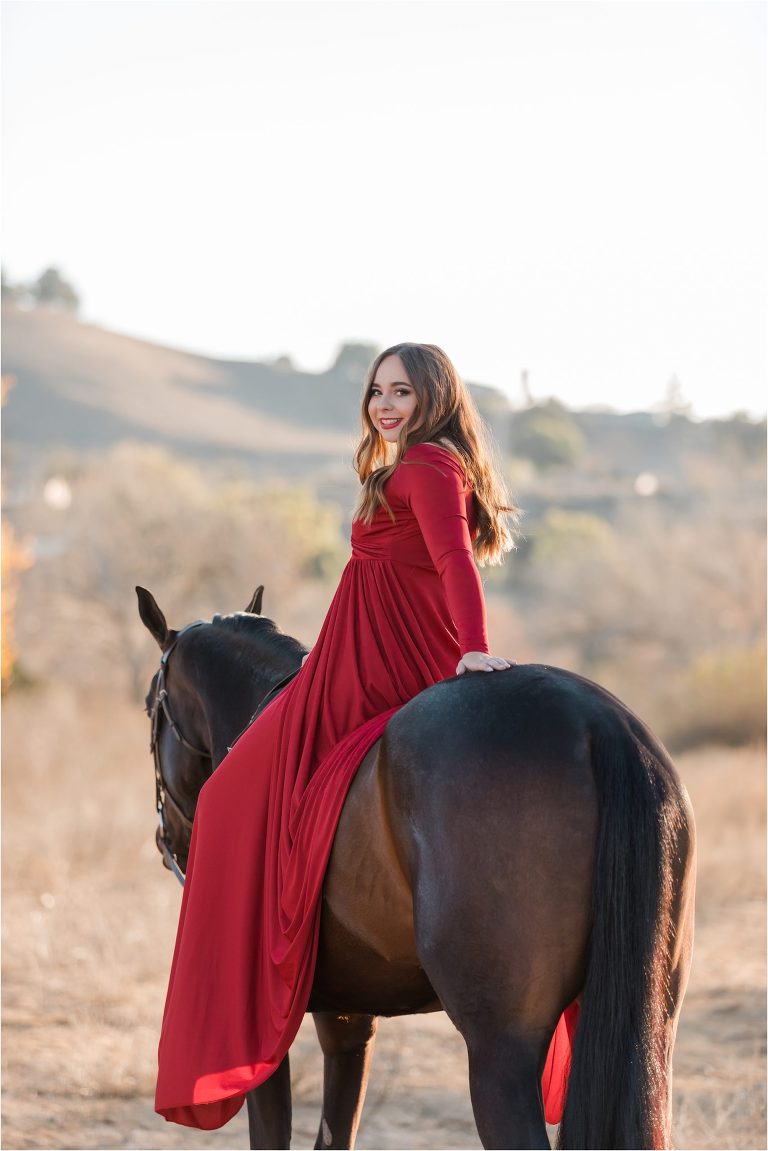 California Horse Photography Shoot at Wheeler Performance Horses in Hollister California by Elizabeth Hay Photography of girl sitting on horse in red dress. 