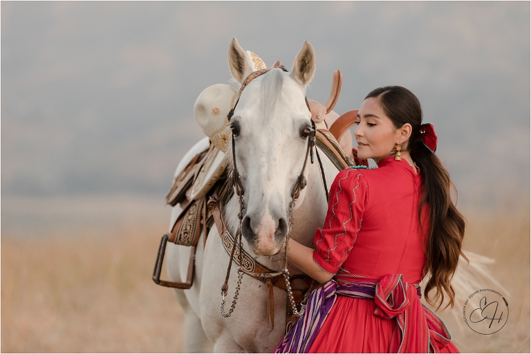 Escaramuza rider wearing red dress and her horse by California Horse Photographer Elizabeth Hay Photography