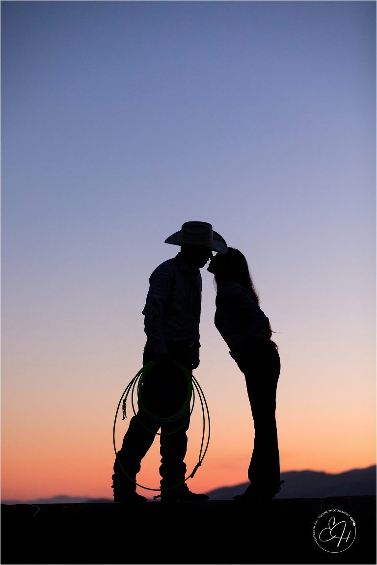 sunset silhouette of western couple kissing by California Horse Photographer Elizabeth Hay Photographer