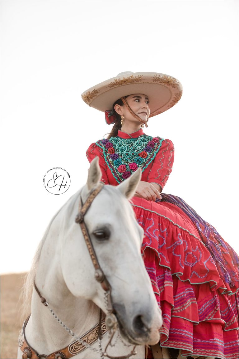 California Vaquero Photo Shoot with woman wearing traditional red dress by California Equine Photographer Elizabeth Hay Photography.