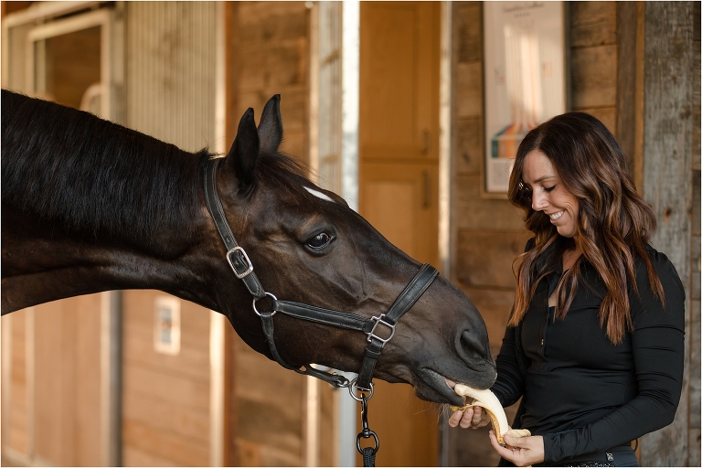 Kasey Perry-Glass and Gorklintgaards Dublet eating his daily banana by California Equine Photographer Elizabeth Hay Photography. horse photography