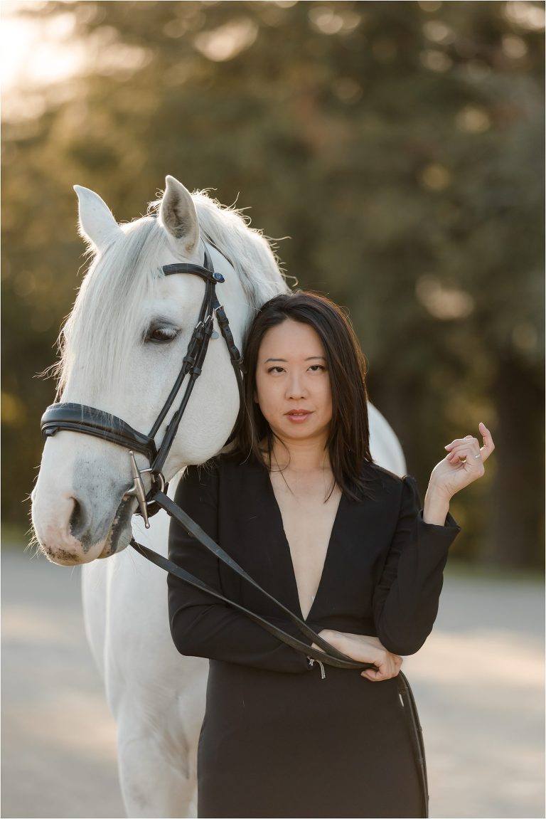 Woman wearing a black deep v-neck dress and white horse by California Horse Photographer Elizabeth Hay Photography.