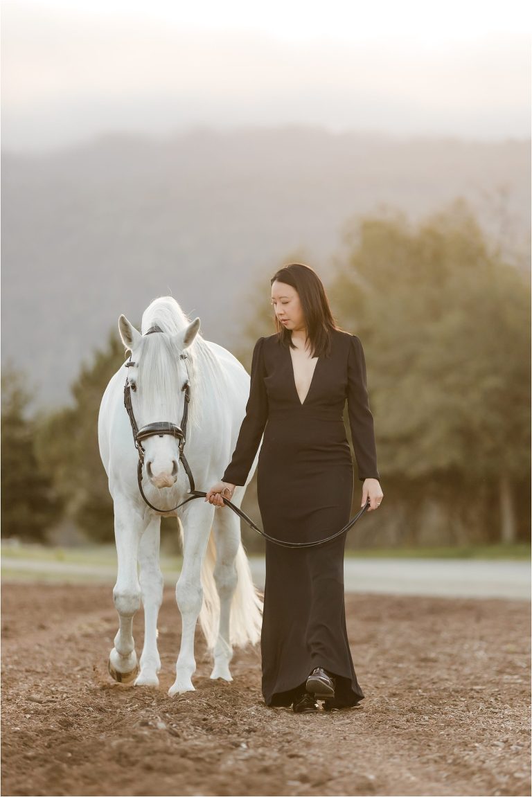Woman wearing a black deep v-neck gown and white Lusitano horse by California Horse Photographer Elizabeth Hay Photography. Equestrian of Color. Asian American equestrian. 